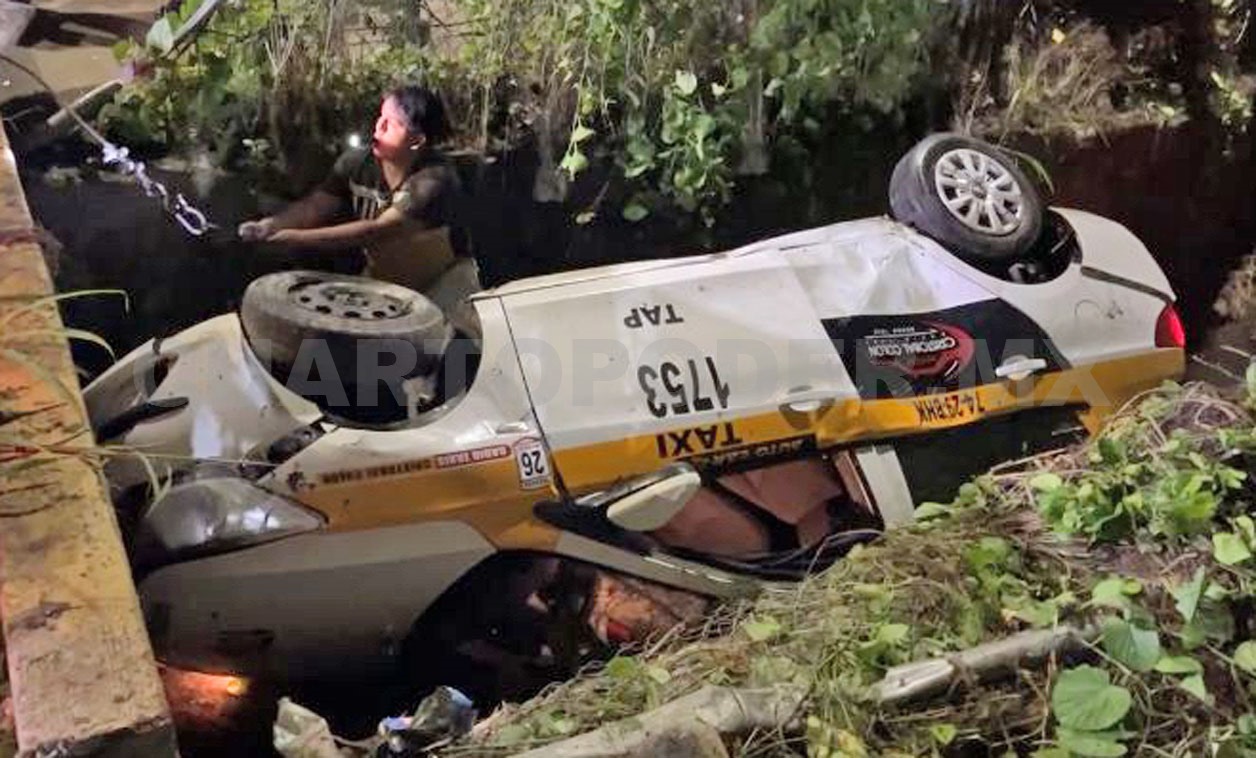 Abandonan auto volcado dentro de dren pluvial
