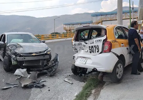 Sedán se estampa en taxi estacionado Sedán se estampa en taxi estacionado