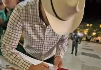Exhiben a artista firmando bandera de México